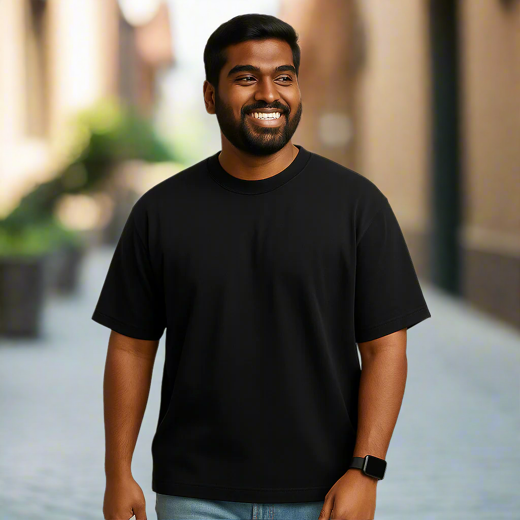 Man wearing a black t-shirt against a beige background